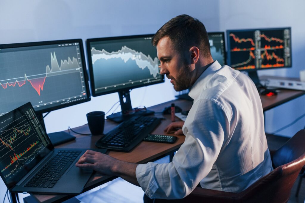 Trading strategies. Stock trader working in the office with exchange technology